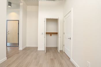A room with a white door and a brown shelf. at RiDE at RiNo Apartments, Denver, CO